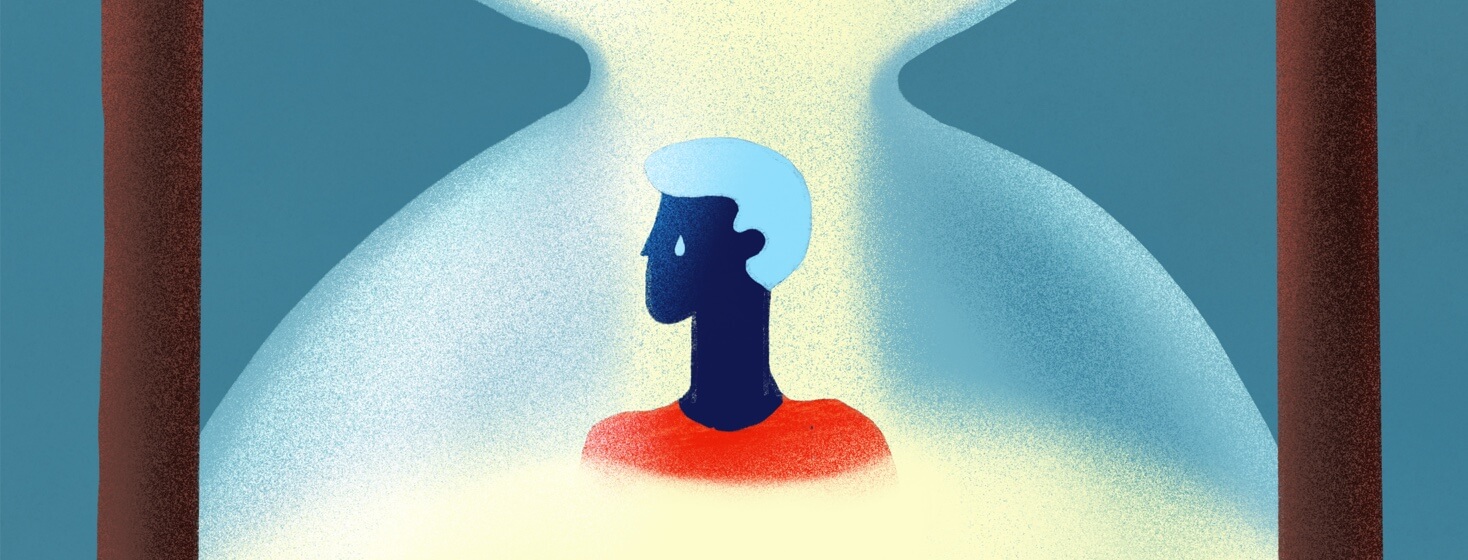 A person inside an hour glass as sand surrounds him